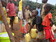 Drilling co doing pump testing as young girls fetch the water